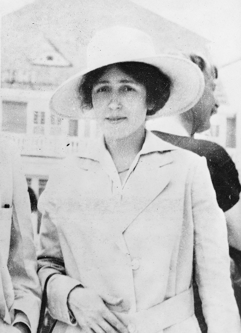A photograph of a young woman wearing a wide-brimmed hat and a jacket.