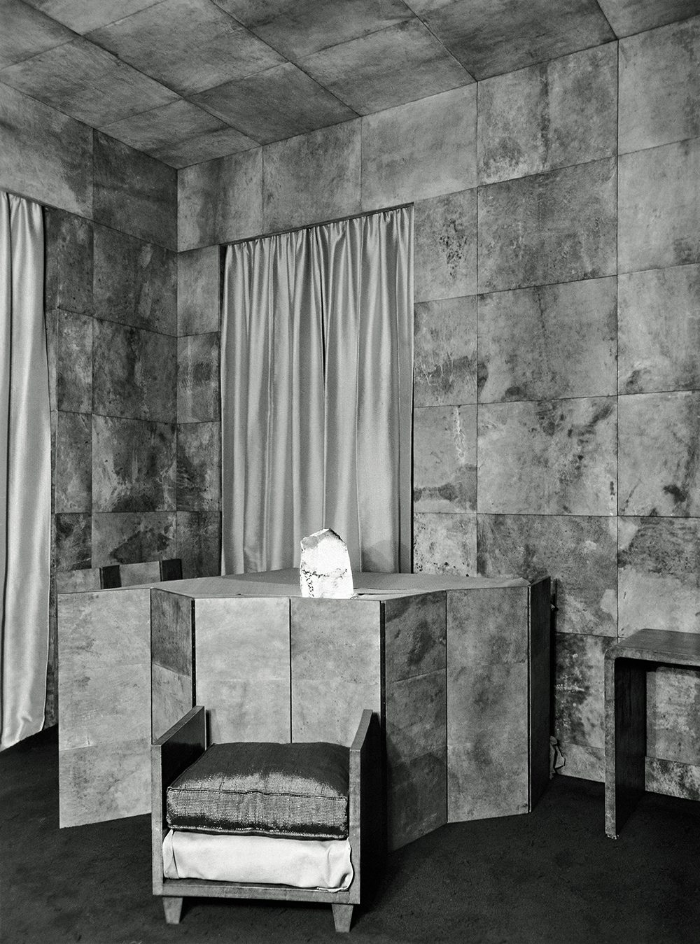 Living room in the Templeton Crocker penthouse, designed by Jean-Michel Frank, with walls and ceiling covered in squares of parchment, a piano hidden behind a low folding screen, and a quartz block lamp,  c. 1930. © Harald Gottschalk.