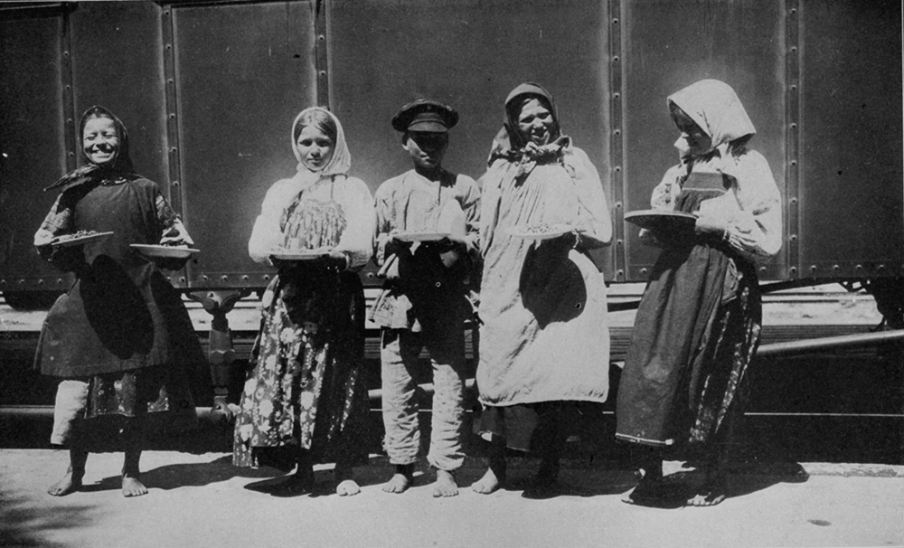 Platform vendors selling plates of food to passengers along the Trans-Siberian route, 1900. Photograph by Michael Ward. From E. Burton Holmes, “The Burton Holmes Lectures, Vol. VIII” (1901). 