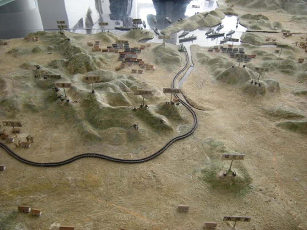 A relief map and model of Port Arthur that shows the extent to which the city and harbor were natural protectorates for the Russian fleet in 1904. Photograph by Matthew Stevenson.