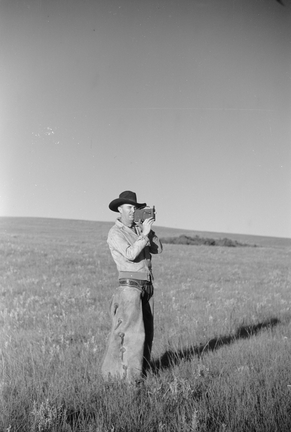 Cowboy with amateur movie camera in Montana, 1939. Photograph by Arthur Rothstein. Library of Congress, Prints and Photographs Division.