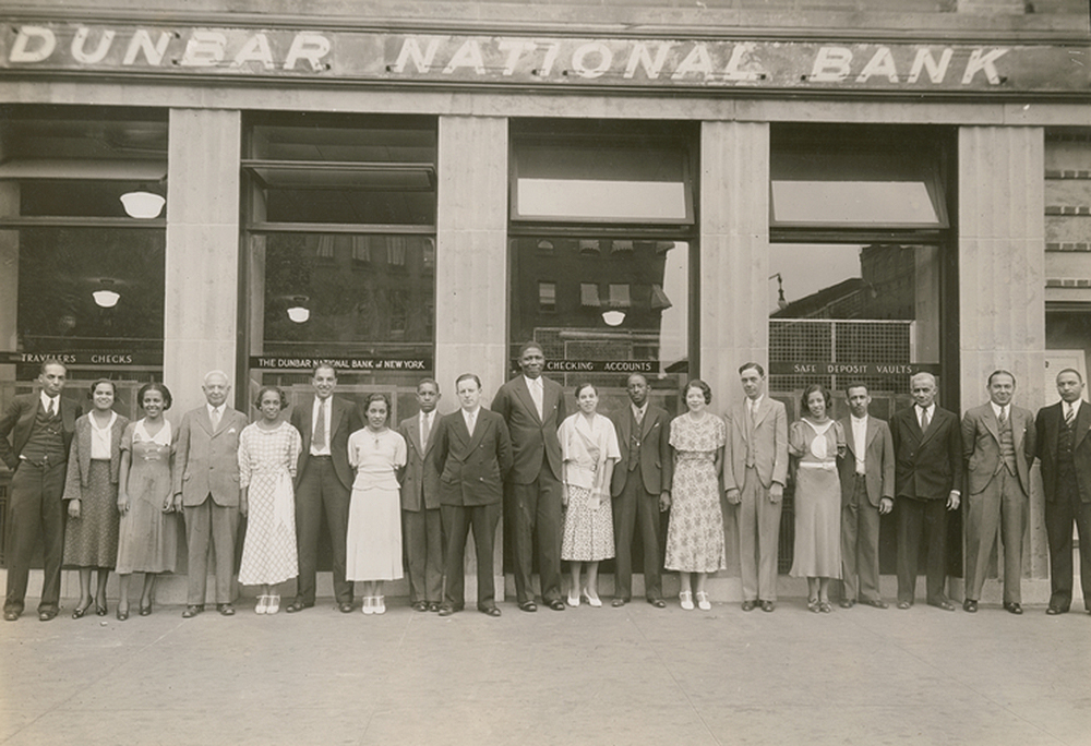 Photograph of the staff of the Dunbar National Bank in Harlem, c. 1930. Schomburg Center for Research in Black Culture, Photographs and Prints Division.