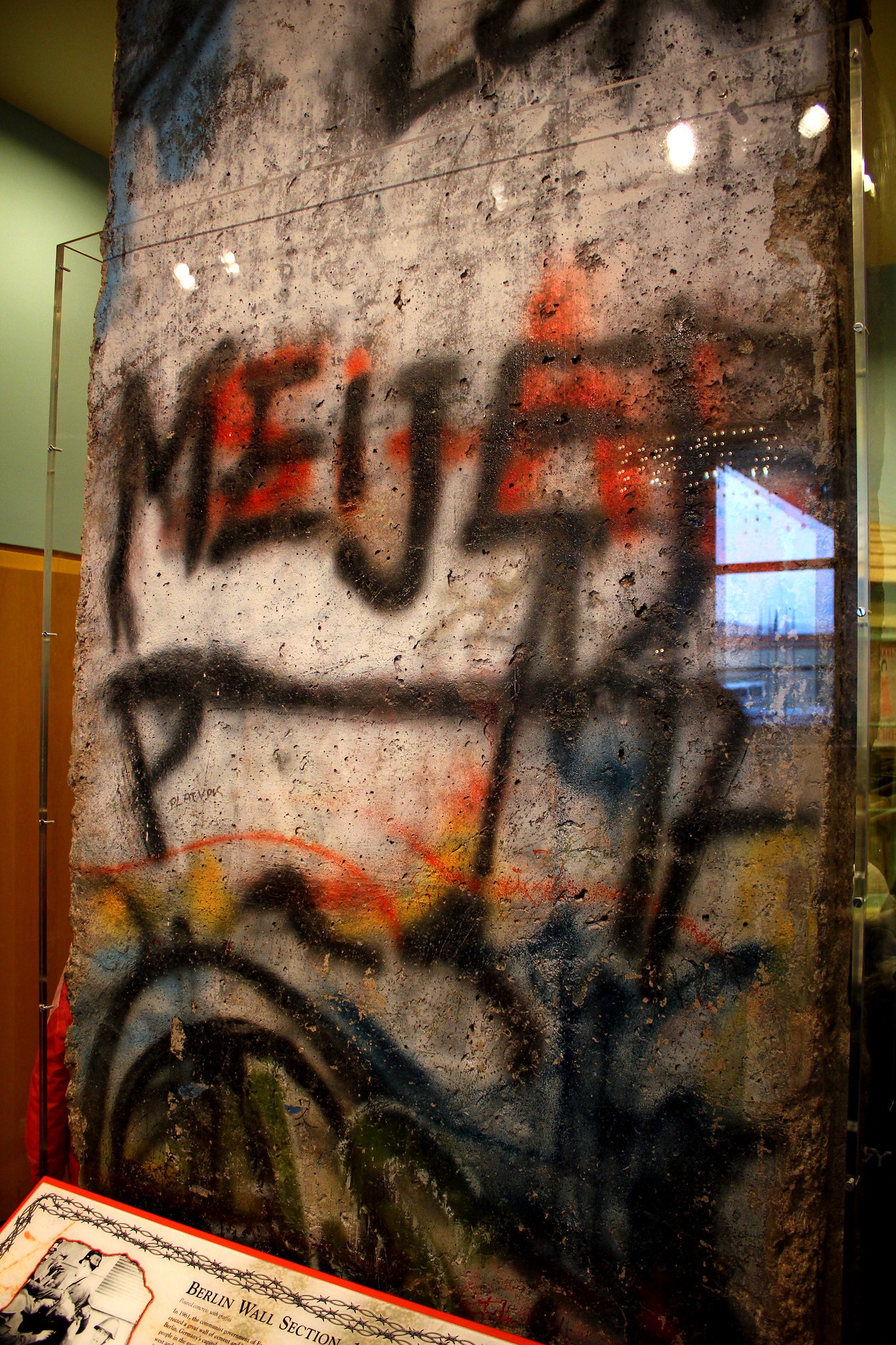 A segment of the Berlin Wall in a museum display with the word Meijer on it.