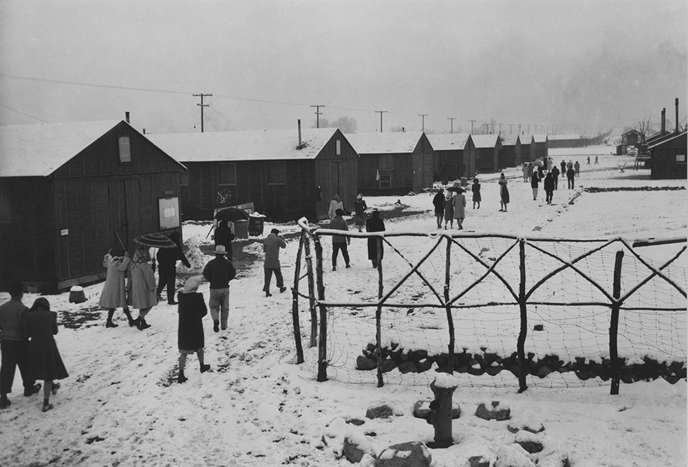 People leaving a Buddhist church in winter at Manzanar Relocation Center, California, 1943. Photograph by Ansel Adams. Library of Congress, Prints and Photographs Division.