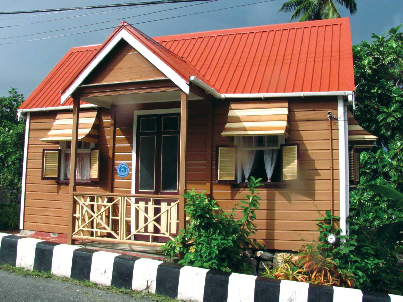 Small beige house with red roof