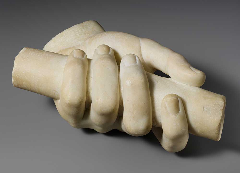 Marble left hand holding a scroll.
