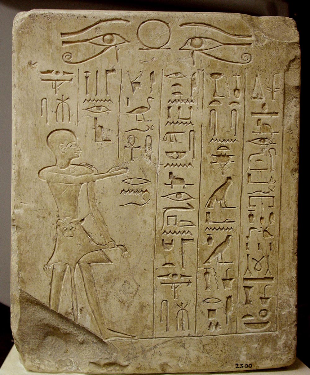 Statue with inscription: An offering that the king gives to Osiris, ruler of eternity, so that he may give a voice offering of bread and beer, meat and poultry, alabaster and linen, incense and oil, and all things good and pure, to breathe in the fragrance of myrrh and frankincense, fresh water, wine, and milk, for the ka of the overseer of the festivals of Osiris, steward of the God’s Wife, Minmose. Made by his son so that his name may live, the first priest of Osiris, Minmose, Egypt, c. 1200 BC.