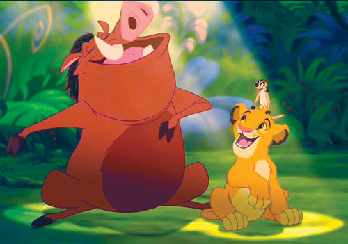 A still from Disney's animated movie The Lion King, depicting three characters, Timon (a meerkat), Pumba (a warthog), and Simba (a lion cub) singing under a spotlit in the jungle.