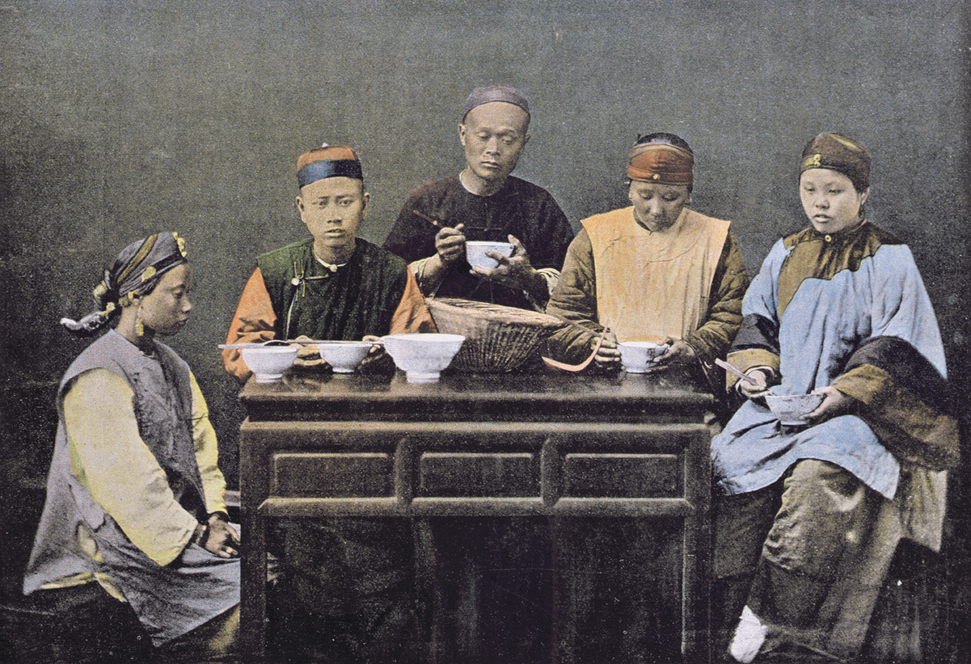 Family having a meal, China, c. 1900