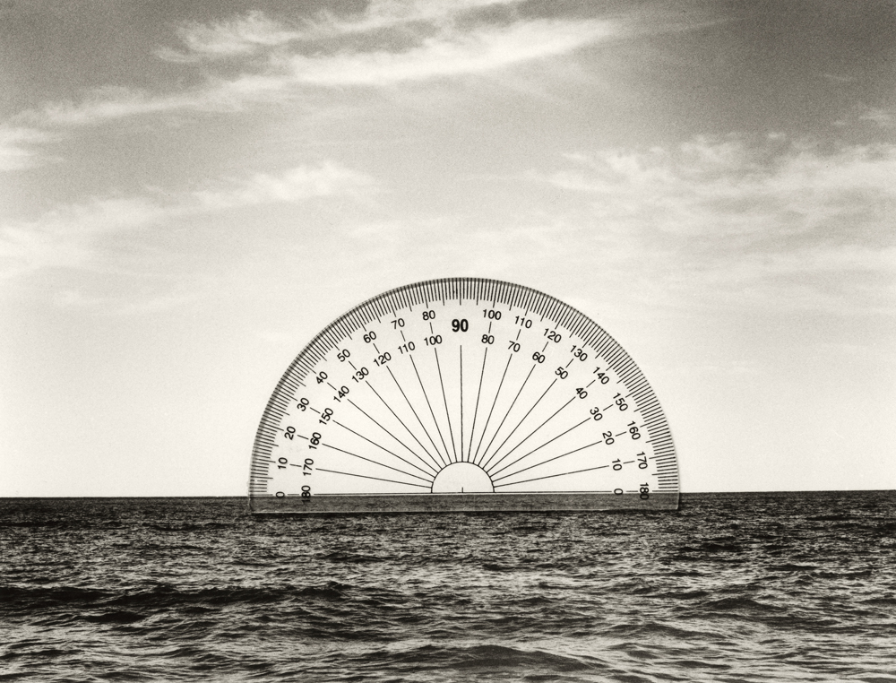 Contemporary art photograph showing a sextant above a seascape.