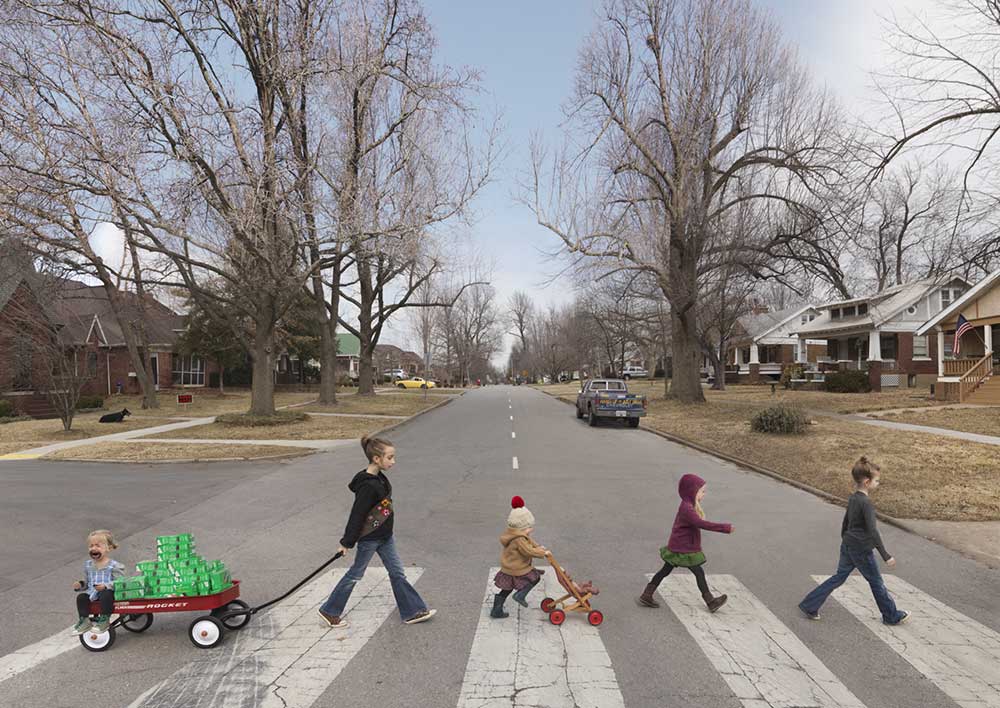 Thin Mints, by Julie Blackmon, 2014. Color photograph of young girls walking across the street, ready to sell Girl Scout cookies.