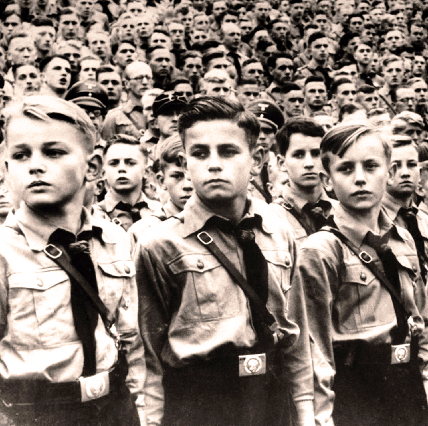 Black and white photograph of young boys at a Hitler Youth rally.