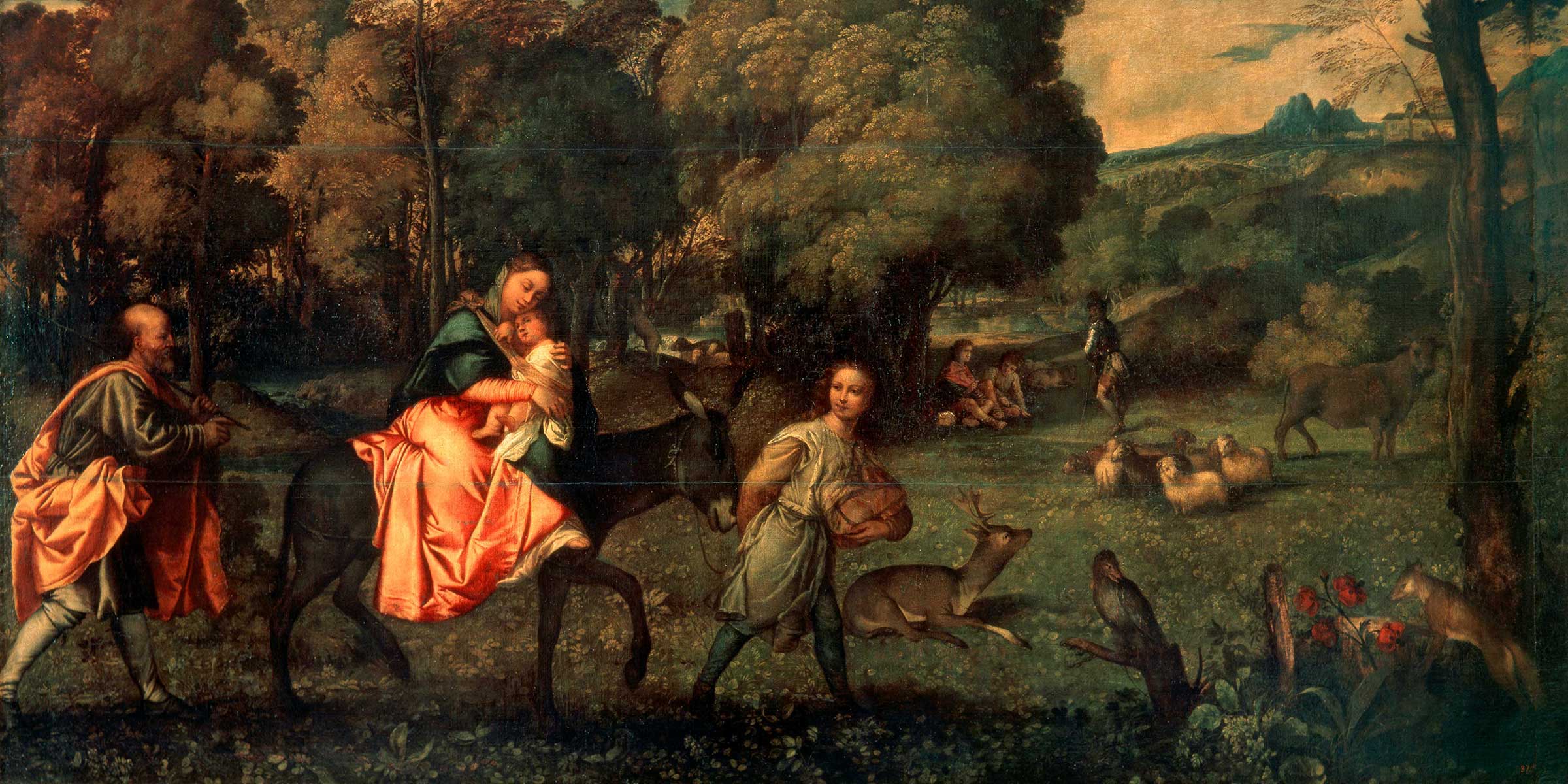 A woman and child on a horse led by a boy and followed by a man in a wooded area with animals
