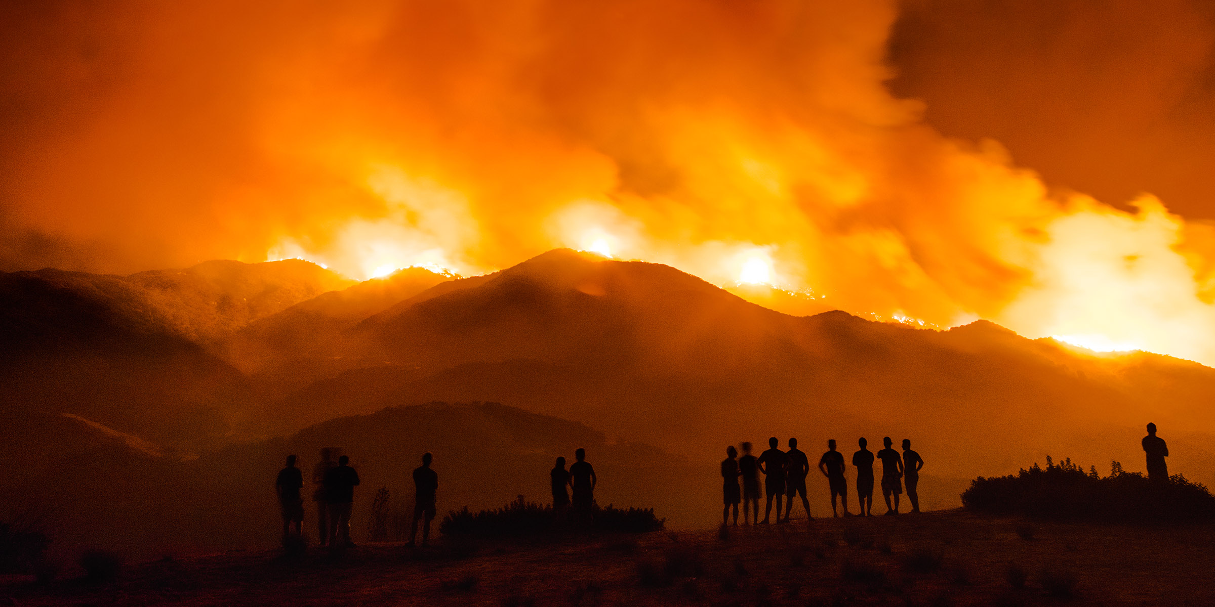 La Tuna Canyon Fire, by Kevin Cooley, 2017. Archival pigment print, 30 x 38½ and 40 x 51½ inches. A crowd gathers in the Los Angeles neighborhood of Tujunga to watch the La Tuna Canyon fire burn in the Verdugo Mountains north of Burbank. © Kevin Cooley, c