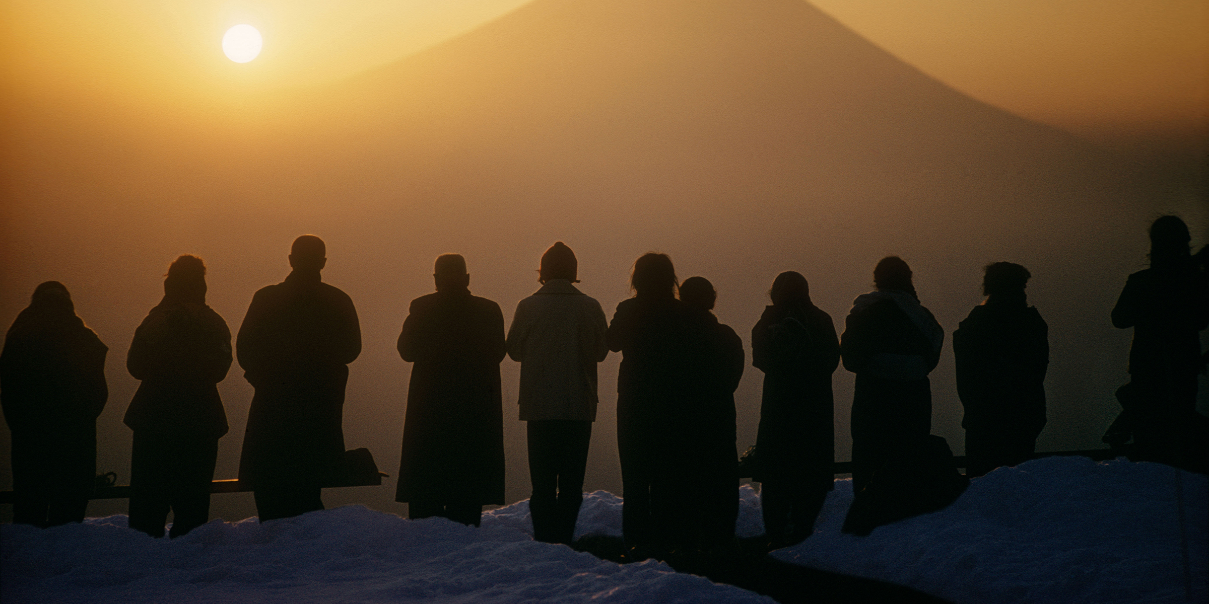 Pilgrims watching the sun rise over Mount Fuji from Mount Shichimen, Japan, 1961. Photograph by Burt Glinn. © Burt Glinn / Magnum Photos.