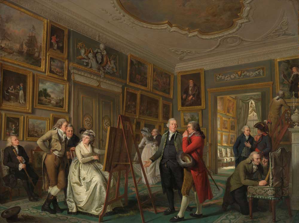 Room turned picture gallery with several people, including a woman at an easel.