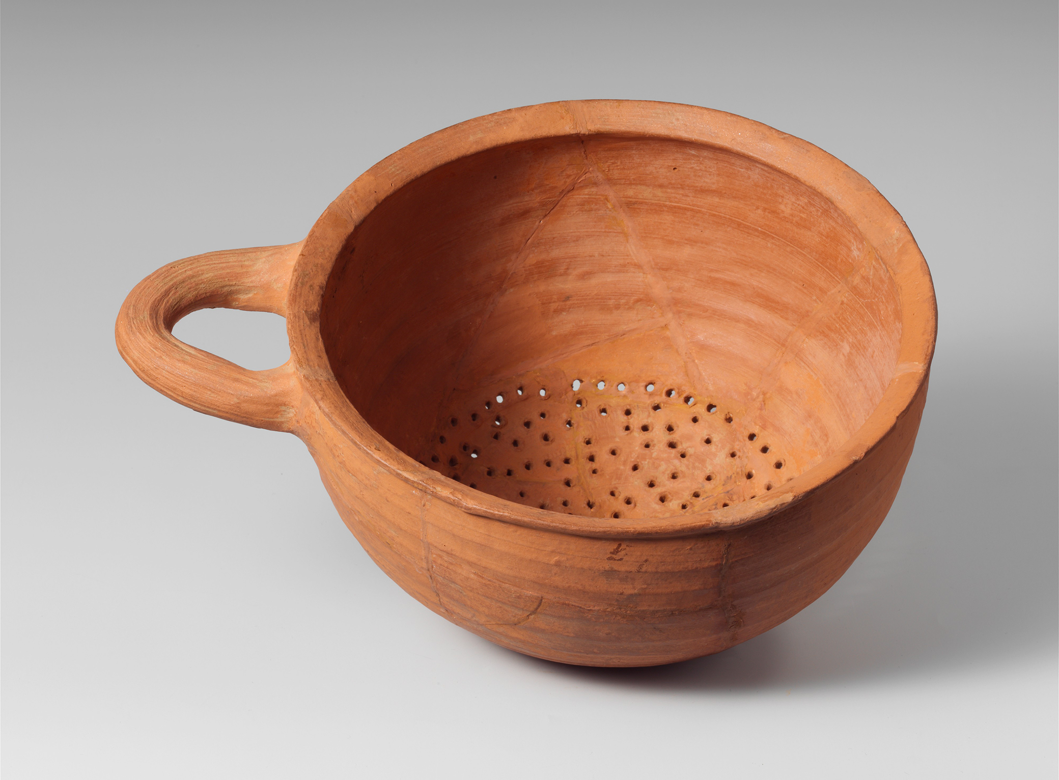 Terracotta hemispherical strainer, sixth century BC. The Metropolitan Museum of Art, Gift of The American Society for the Exploration of Sardis, 1914. Terracotta hemispherical strainer, sixth century BC. The Metropolitan Museum of Art, Gift of The American Society for the Exploration of Sardis, 1914.