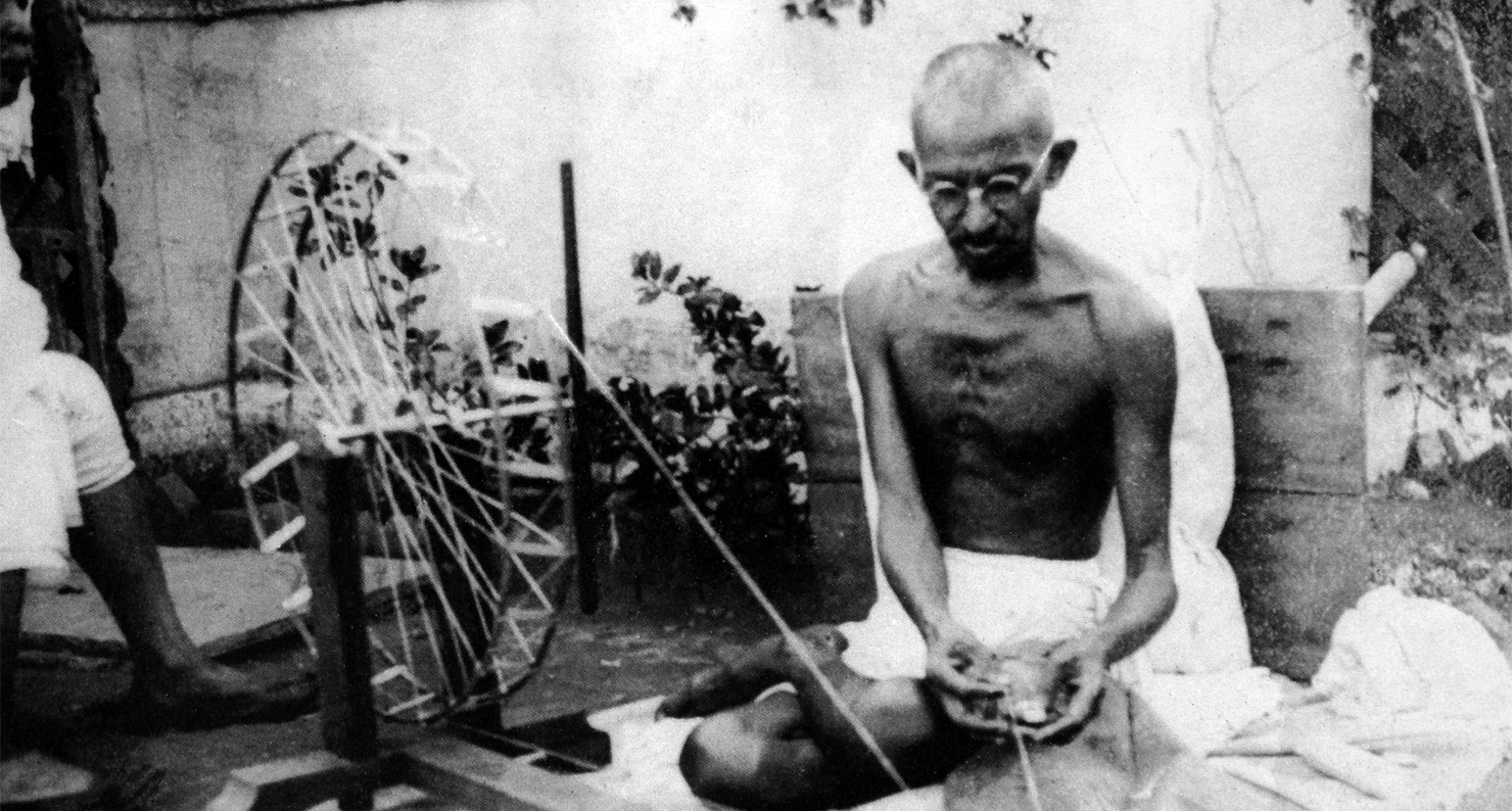 Mahatma Gandhi spinning yarn, in the late 1920s