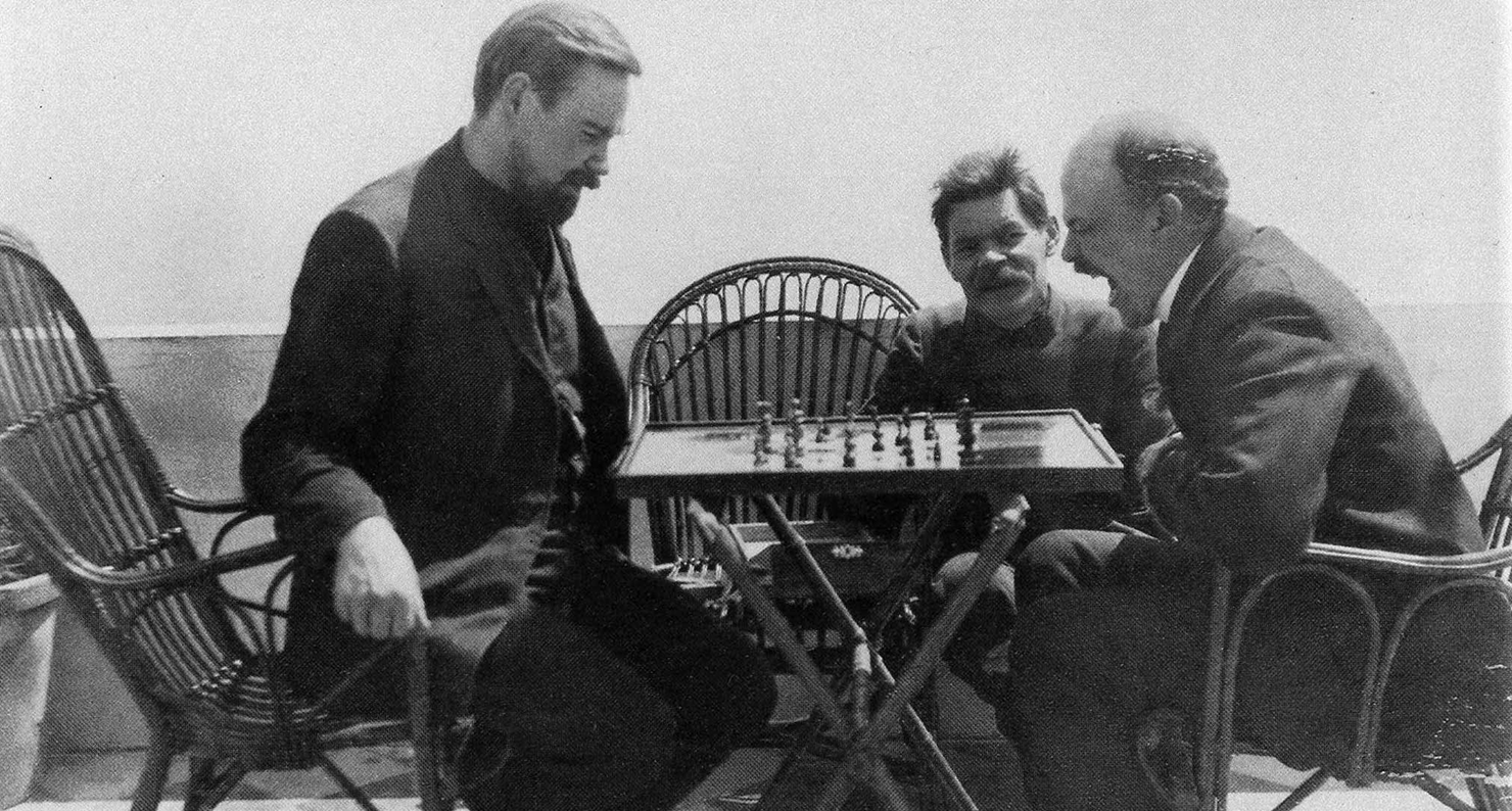 Vladimir Lenin (right) plays chess with Alexander Bogdanov (left) during a visit to Maxim Gorky (center), 1908.