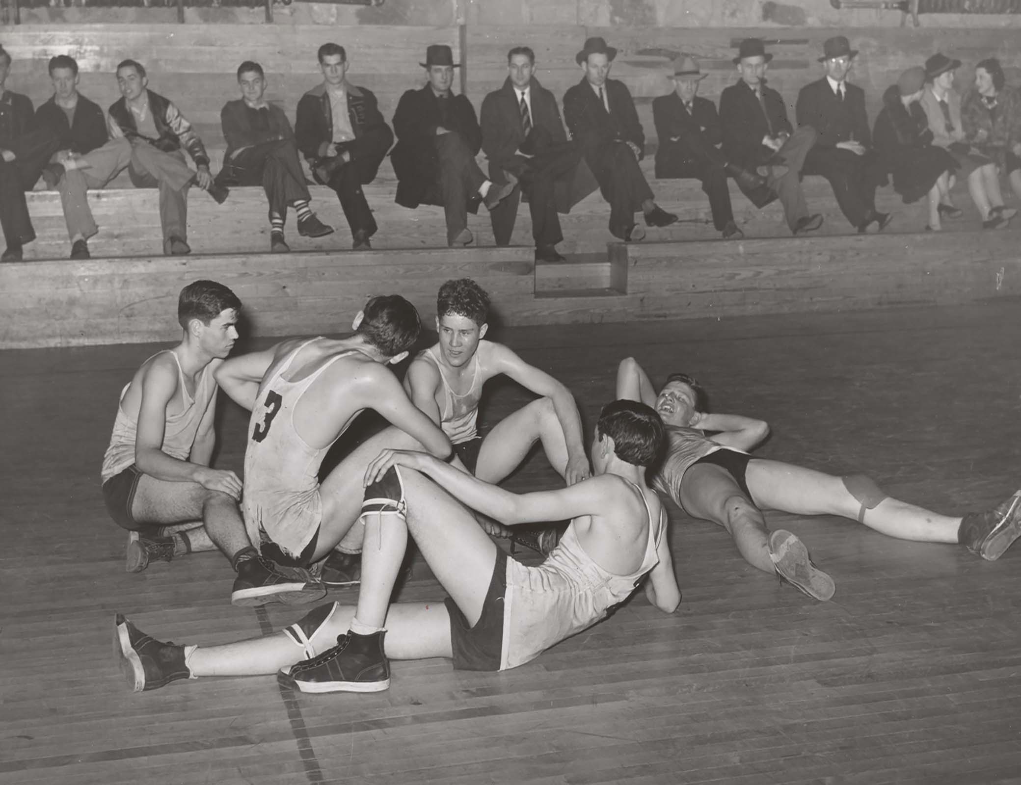 Basketball players resting between periods, Eufaula, Oklahoma, 1940.