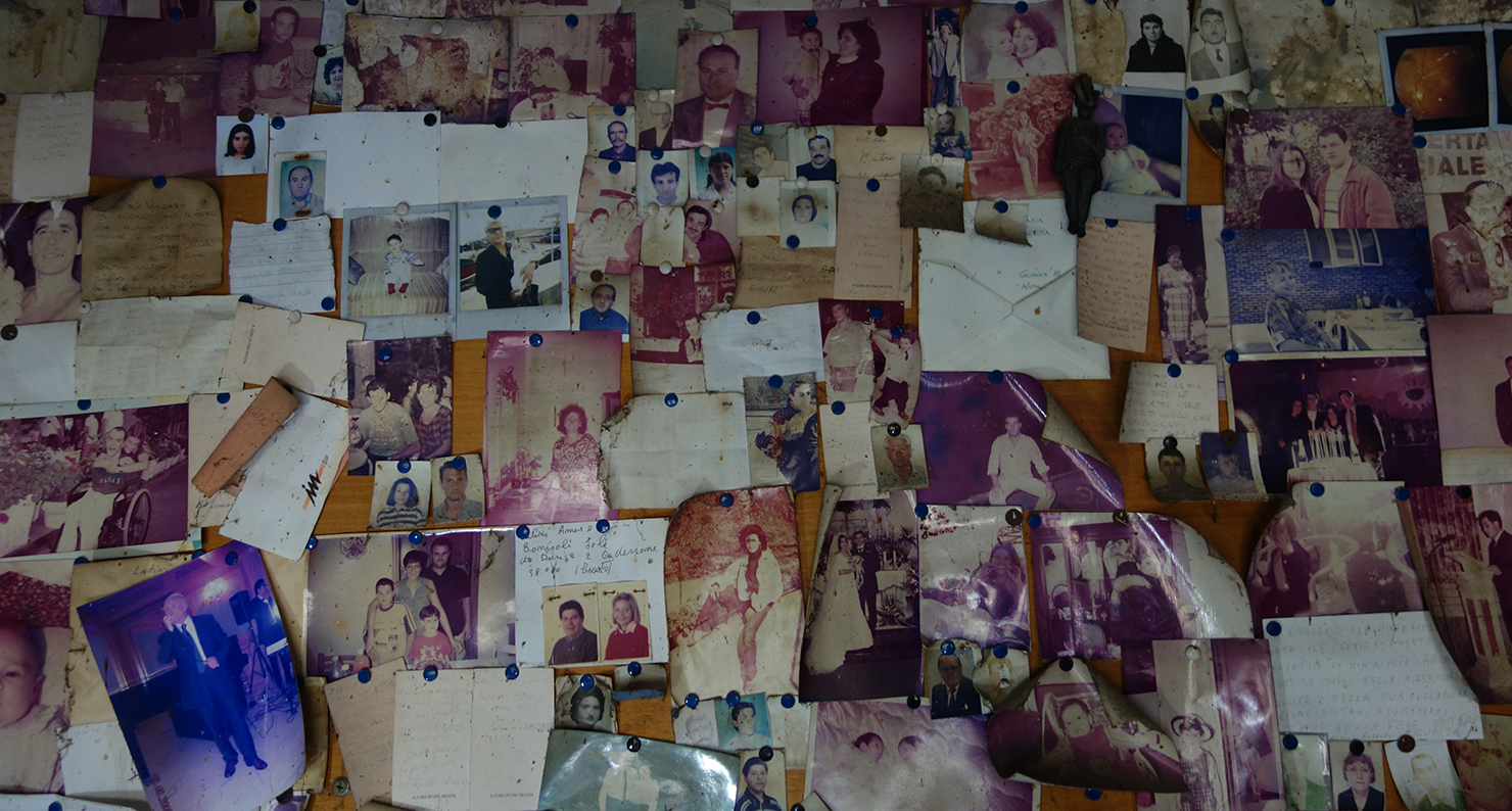 Photographs left by those who have prayed to Uncle Vincent. Photograph by Elizabeth Harper. Photographs left by those who have prayed to Uncle Vincent. Photograph by Elizabeth Harper.