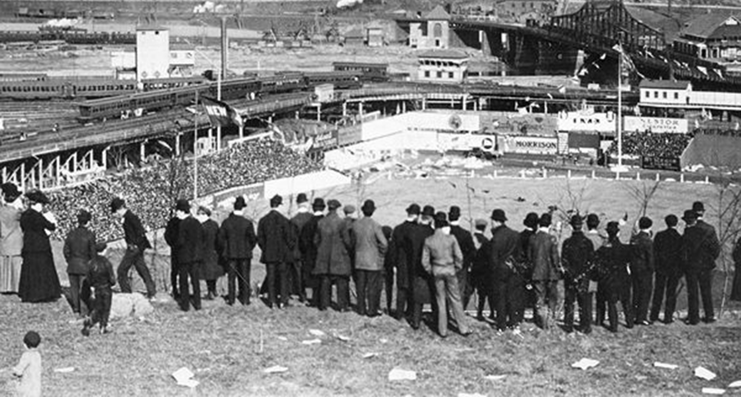 Baseball fans stand on Coogan’s Bluff to watch the New York Giants play the Chicago Cubs, Polo Grounds, New York City, September 23, 1908.