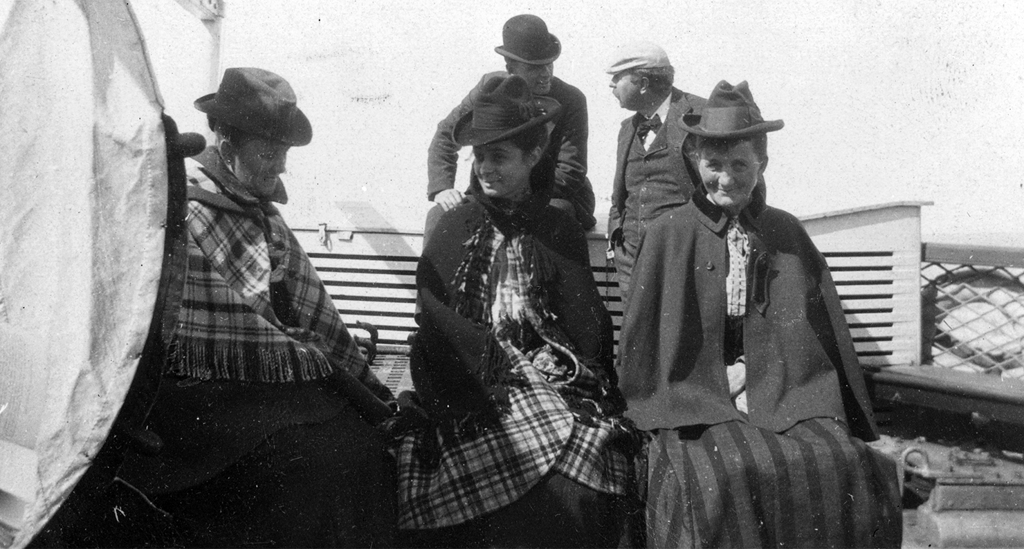 Three women, two men on ship's deck, late nineteenth-early twentieth centuries. Three women, two men on ship's deck, late nineteenth-early twentieth centuries.