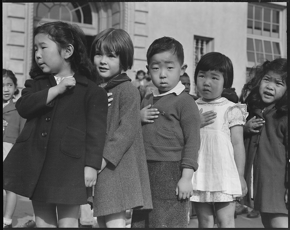 Many children of Japanese ancestry attended Raphael Weill Public School in San Francisco prior to evacuation. This scene shows first graders during flag pledge ceremony, 1942. Photograph by Dorothea Lange. National Archives at College Park.