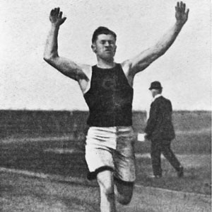 A black and white photograph of a man, Jim Thorpe, running.