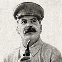 A black-and-white photograph of Joseph Stalin wearing a cap