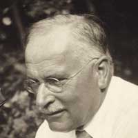 Photograph of a man with glasses and a white mustache