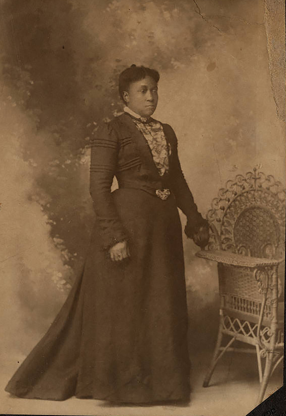 Dr. Wiley’s hair is parted and pulled back. Standing in a high-collared, long dress, she appears solemn and confident. Her left hand rests on an ornate wicker chair. Caroline Still [Wiley] Anderson, c. 1880. Photograph by J.A. Hurst. William Still Collection.