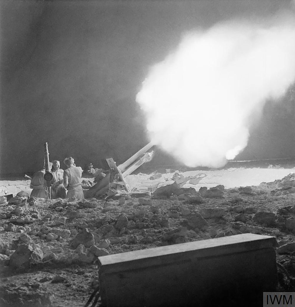 British 25-pounder guns fire at Erwin Rommel’s Afrika Korps on the night of June 2, 1942, during the Battle of Gazala. Photograph by William George Vanderson. © Imperial War Museums.