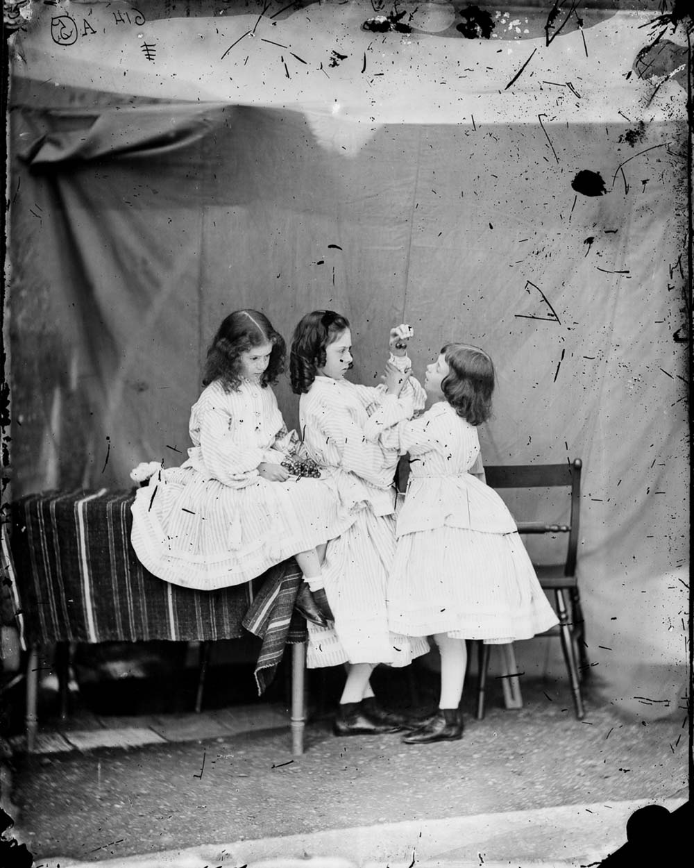 Edith, Lorina, and Alice Liddell in “Open Your Mouth and Shut Your Eyes,” by Lewis Carroll, 1860. 