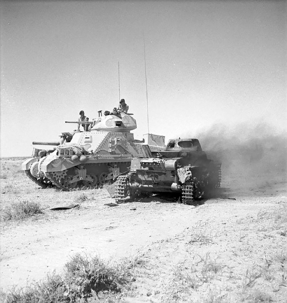 A British M3 Grant tank next to a knocked-out German Panzerkampfwagen I light tank in North Africa, June 6, 1942. © Imperial War Museums.