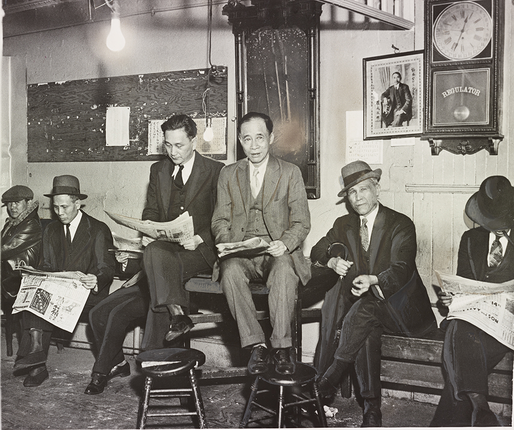 Hip Sing Tong officials read the news late at night, 1933. Photograph by William C. Greene.