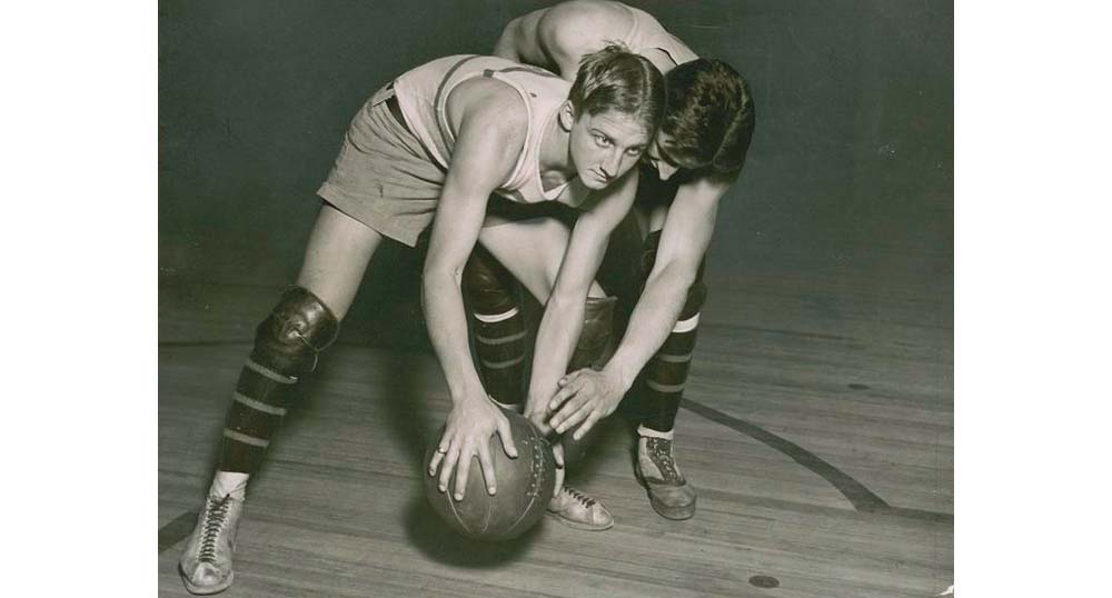 Guarding in basketball, c. 1920. 