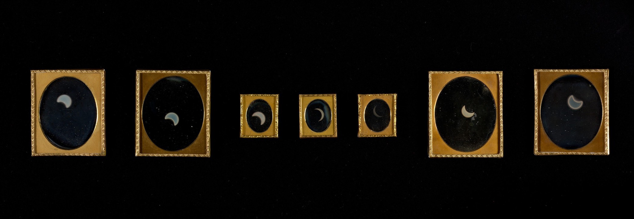 A series of seven daguerrotypes showing the progression of a solar eclipse.