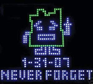 an LED image of a robot and the words never forget.