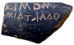 a photograph of a potsherd with a name scratched into it.