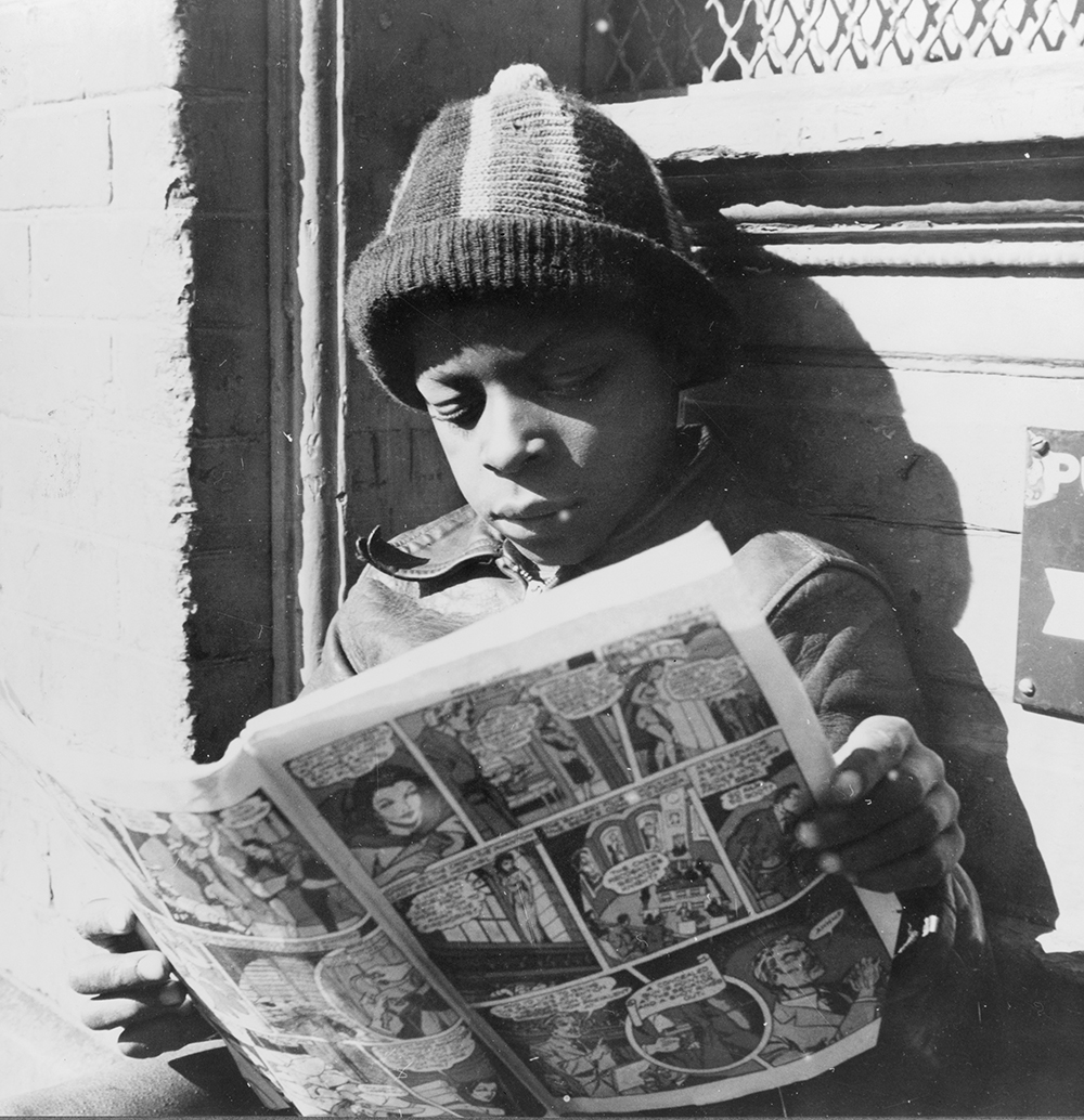 Child reading a funny paper on a doorstep in the Southwest section of Washington, DC, 1942. Photograph by Gordon Parks. Library of Congress, Prints and Photographs Division.