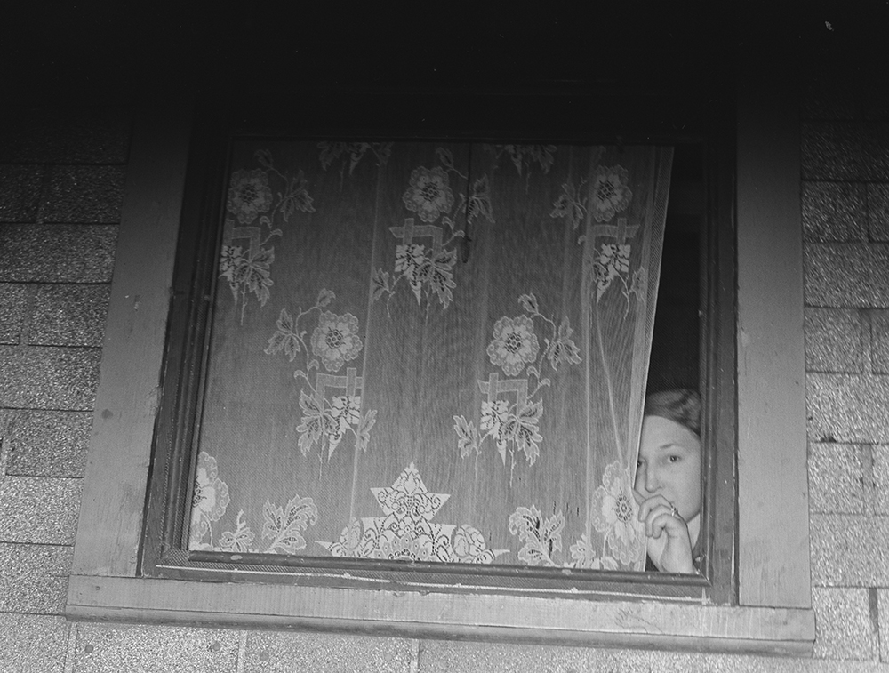 Photograph of prostitute at window in Peoria, Illinois, 1938, by Arthur Rothstein. Library of Congress, Prints and Photographs Division, Office of War Information.