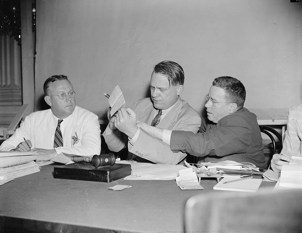 Photograph of the House Committee on Un-American Activities considering evidence against Hollywood by Harris & Ewing, 1938.