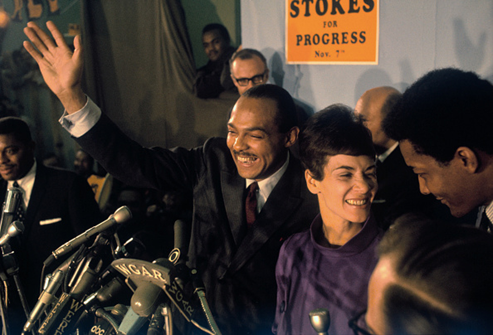 Carl Stokes with his wife, Shirley, acknowledges cheers of crowd at his campaign headquarters election night. Bettman/Getty Images.