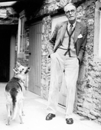 Photograph of British novelist and editor J.R. Ackerley with dog.
