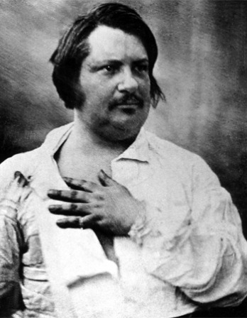 Image of French writer Honoré de Balzac with hand on chest.