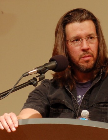 photograph of David Foster Wallace speaking at a podium