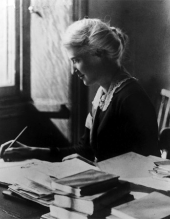 Black and white photograph of British social reformer Eglantyne Jebb at a desk.