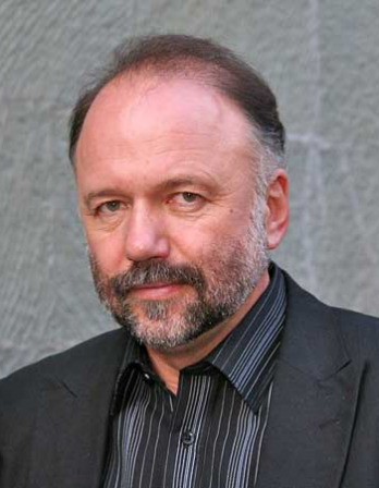 Andrey Kurkov Man with a graying beard wearing a dark suit jacket
