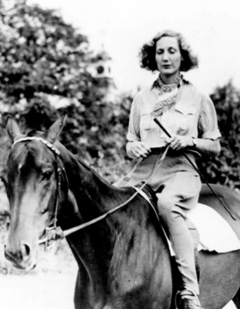 Photograph of pilot, horse trainer, writer, and adventurer Beryl Markham on horseback.